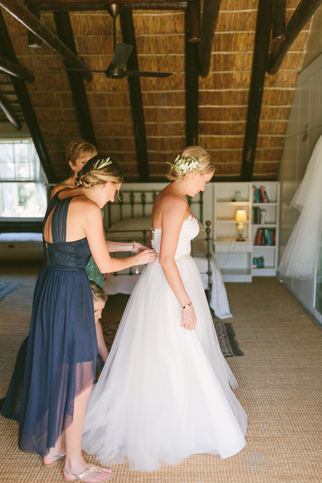 Bride Getting Dressed by Kristi Agier