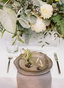 organic industrial wedding place setting with olive decorations