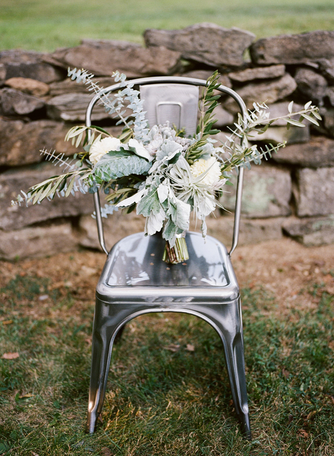 industrial chair with olive leaf and white flower bouquet