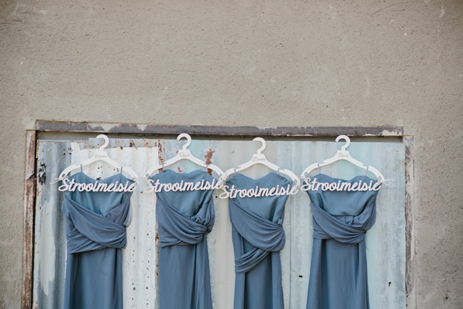 Long Dark Grey Bridesmaid Dresses on Custom Hangers | Credit: Carolien & Ben