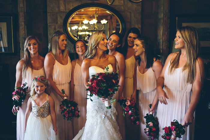 Bridesmaids in Blush with Red Bouquets | Credit: Knot Just Pics