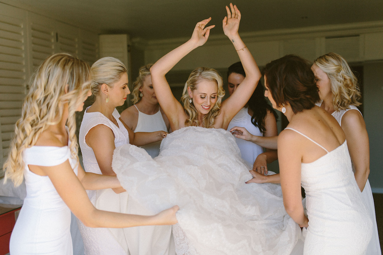 Bridesmaids Helping Bride | Credit: Kikitography