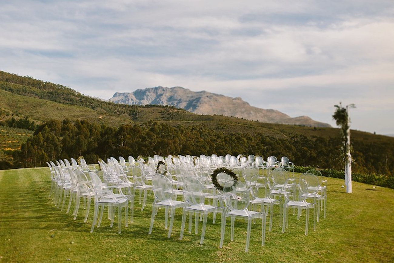 Vineyard Ceremony with Ghost Chairs | Credit: Kikitography