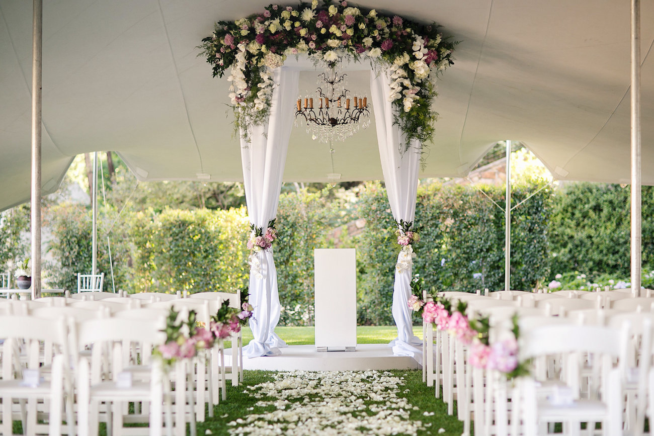 Luxurious Floral Wedding Ceremony Decor with Draped Floral Arch | Credit: Tyme Photography & Wedding Concepts