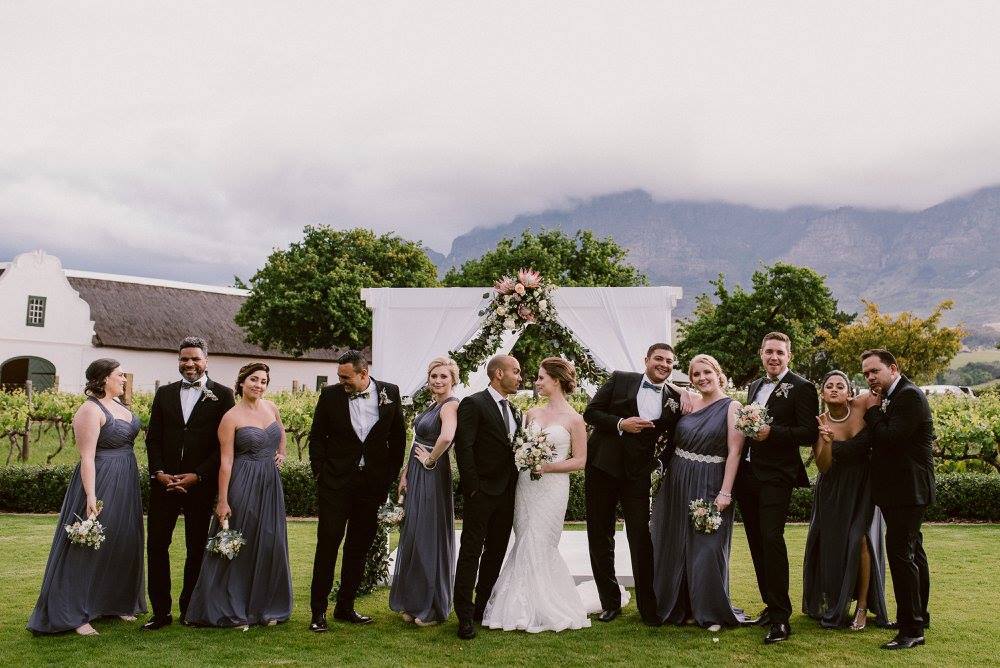 Wedding Party with Protea Arch | Image: Lad & Lass Photography