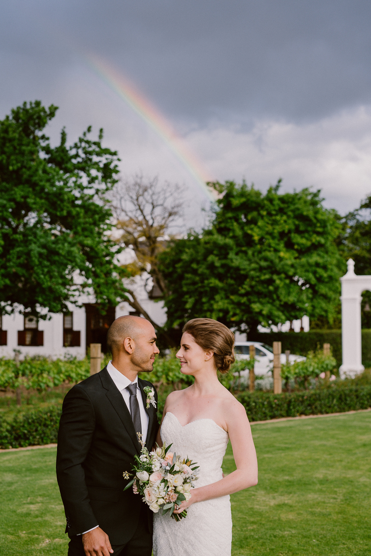 Bride and Groom with Rainbow | Image: Lad & Lass Photography