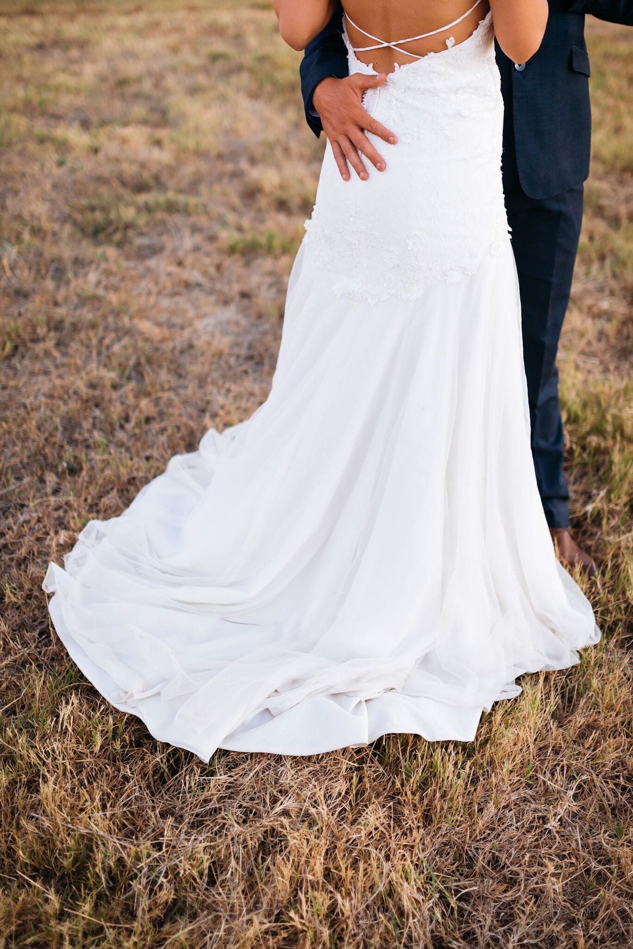 Delicate low back wedding dress with train | Credit: Matthew Carr