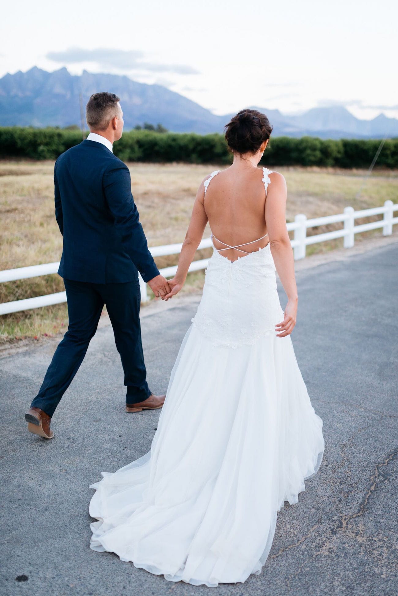 Bride in strappy low back wedding dress with criss-cross detail | Credit: Matthew Carr