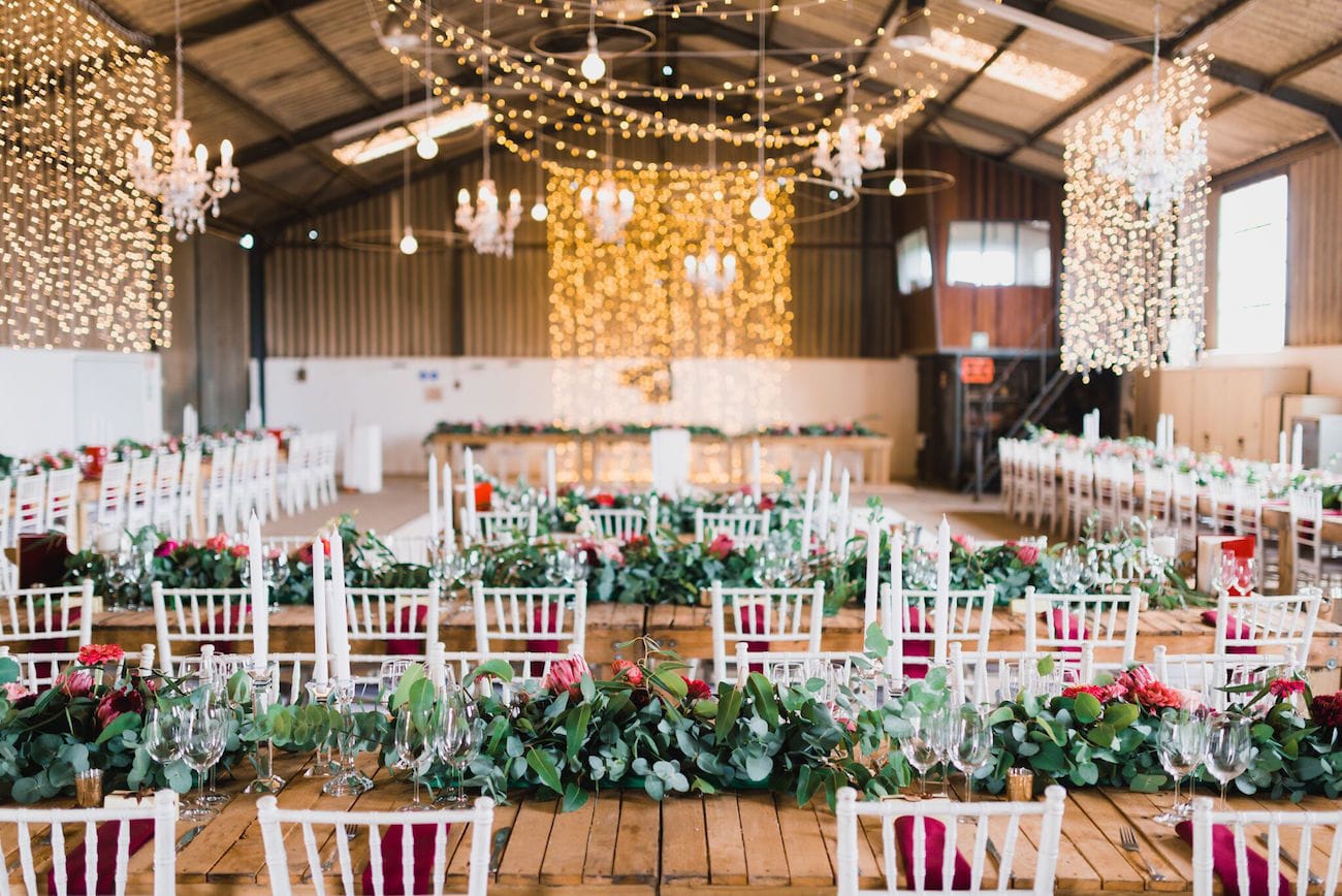 Barn wedding reception with twinkle light curtains | Credit: Matthew Carr