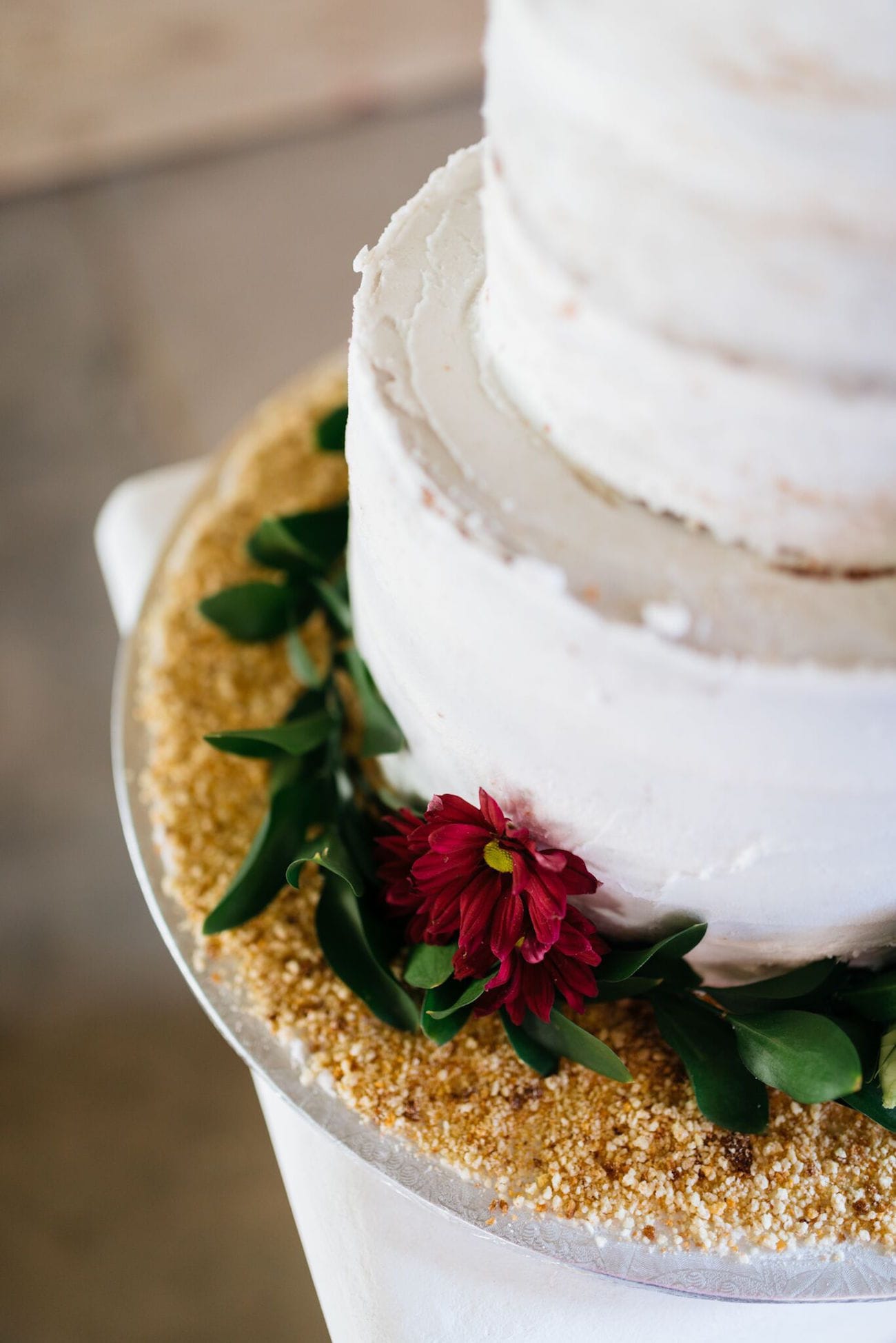 Cake decorated with glitter and greenery | Credit: Matthew Carr