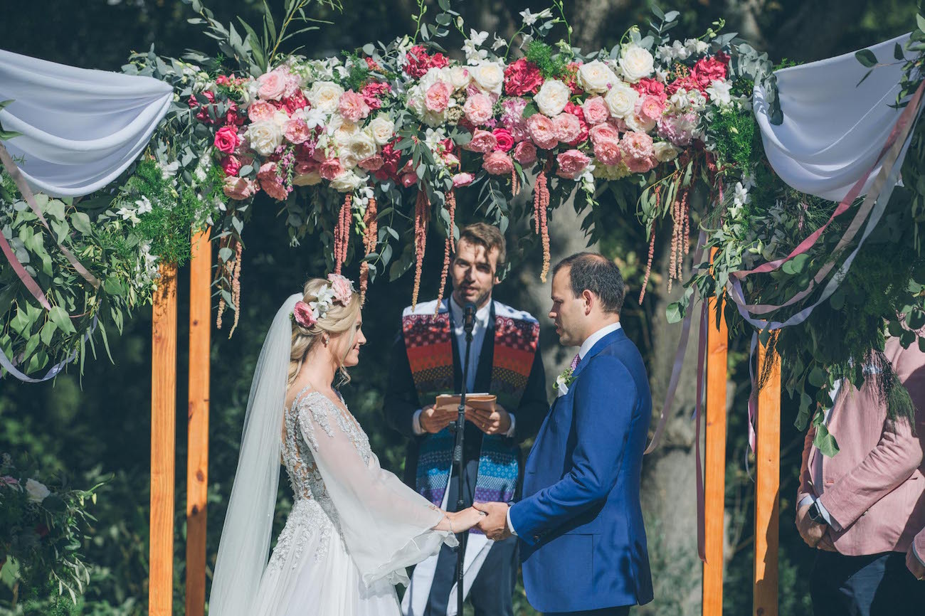 Vineyard Wedding Ceremony with Floral Arch | Credit: Shanna Jones