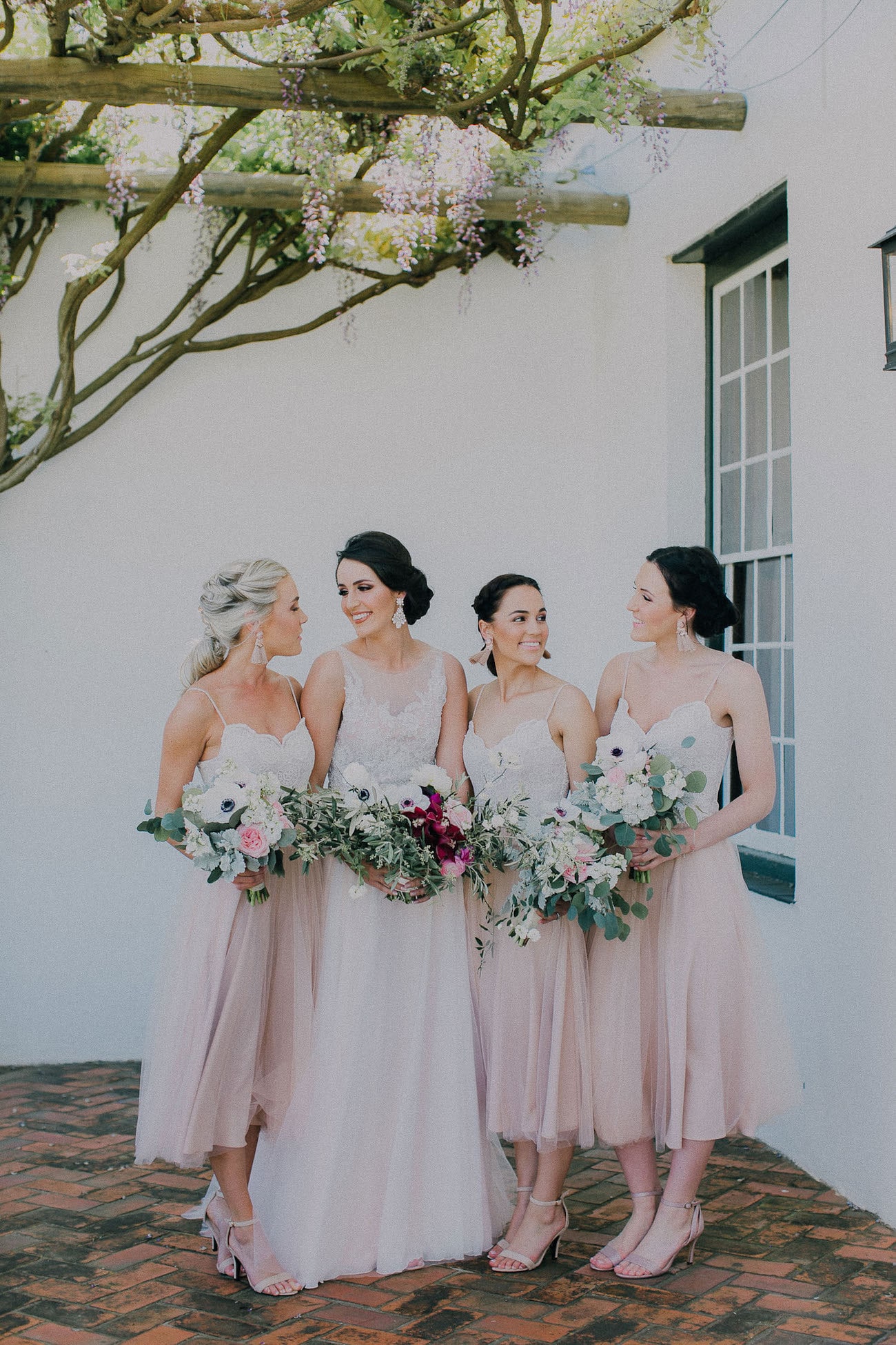 Bridesmaids in Blush Tulle Tea Length Dresses | Image: Michelle du Toit