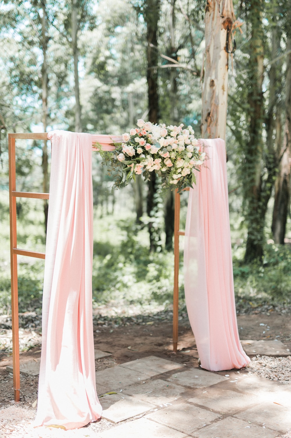 Draped Blush Floral Arch | Image: Bright Girl Photography