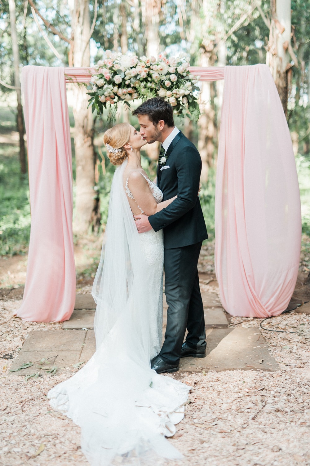 Blush Draped Floral Arch Wedding Ceremony | Image: Bright Girl Photography