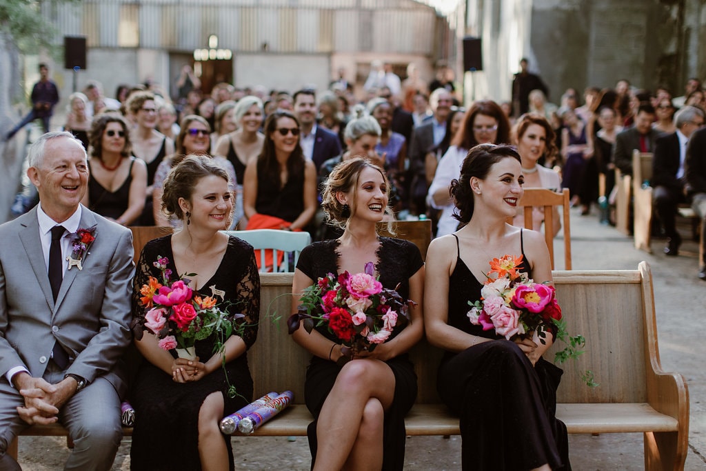 Bridesmaids in Black Dresses with Bold Bouquets | Image: Jenni Elizabeth